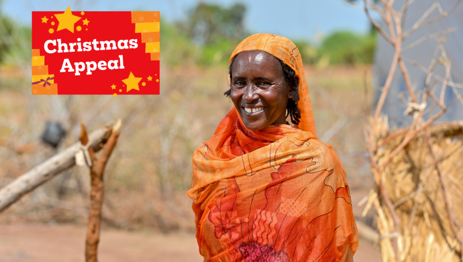 Shede, wearing orange and smiling.
