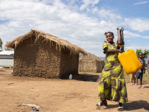 Chance carries a large canister of water 